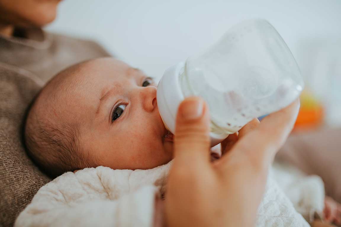 Bottle feed a baby