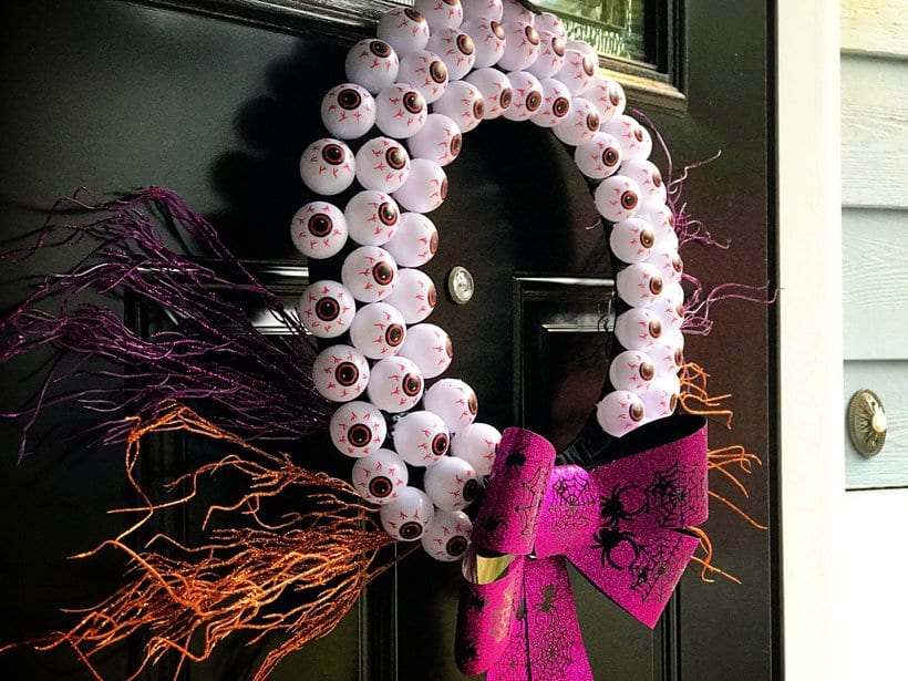DIY Halloween Crafts- create this beautiful Halloween Eyeball Wreath that is sure to wow all of your neighbors this holiday season. This cheap Halloween project is easy to do with kids and won't break your bank account but will look like a million bucks. #halloween