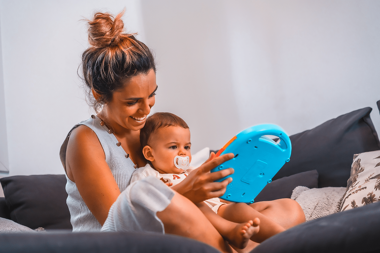 Mother and baby looking at an Amazon Kindle Fire on the couch
