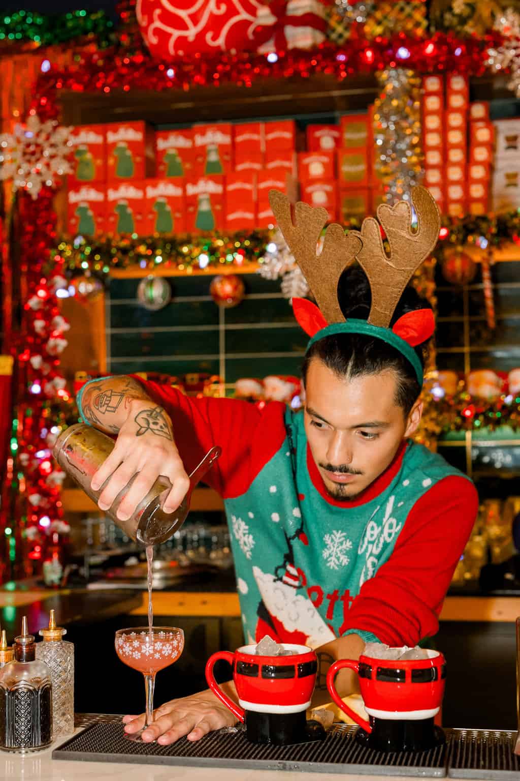 Bartender making drinks at Miracle Bar in Santa Barbara at Christmas