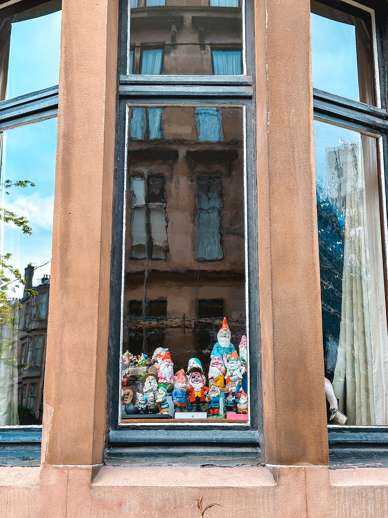 Trolls and gnomes in a window of a home in Glasgow near University of Glasgow scotland- - photo by Keryn Means editor of TwistTravelMag.com