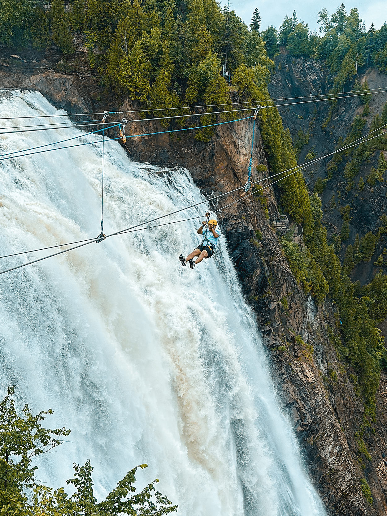 Quebec City 4-Day Itinerary: A Girls’ Getaway Guide 21 Person zip ling across Montmorency Falls in Quebec City Canada- photo by Keryn Means, TwistTravelMag.com