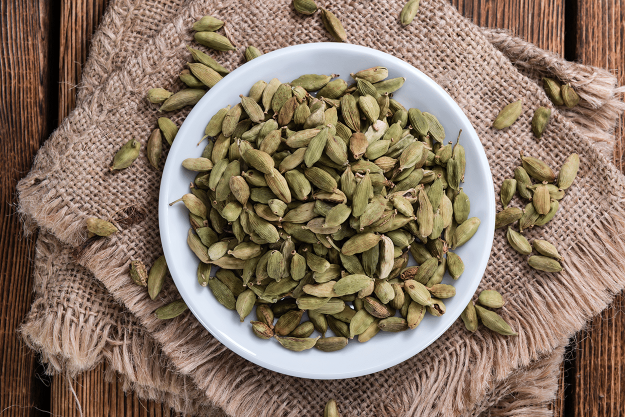Cardamom Simple Syrup 3 Green Cardamon Pods on a table