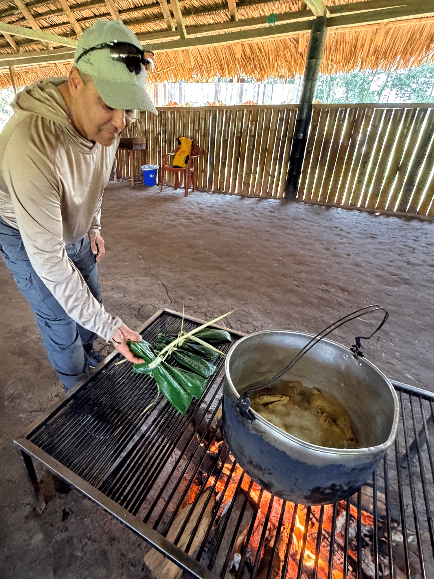 Exhaling in the Amazon: Finding a Floating Sanctuary on the Wild Napo 9 Shellie's husband placing maito on the fire