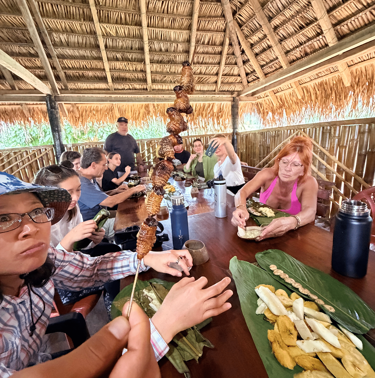 Exhaling in the Amazon: Finding a Floating Sanctuary on the Wild Napo 10 Grubs on a stick at Kichwa lunch