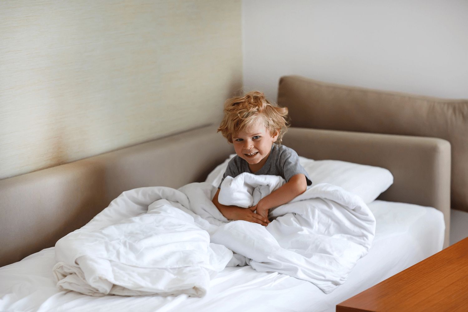 17 Years of Family Travel Taught Us Every Trick for Fitting 4 People in a Hotel Room 1 Child sleeping on a hotel couch