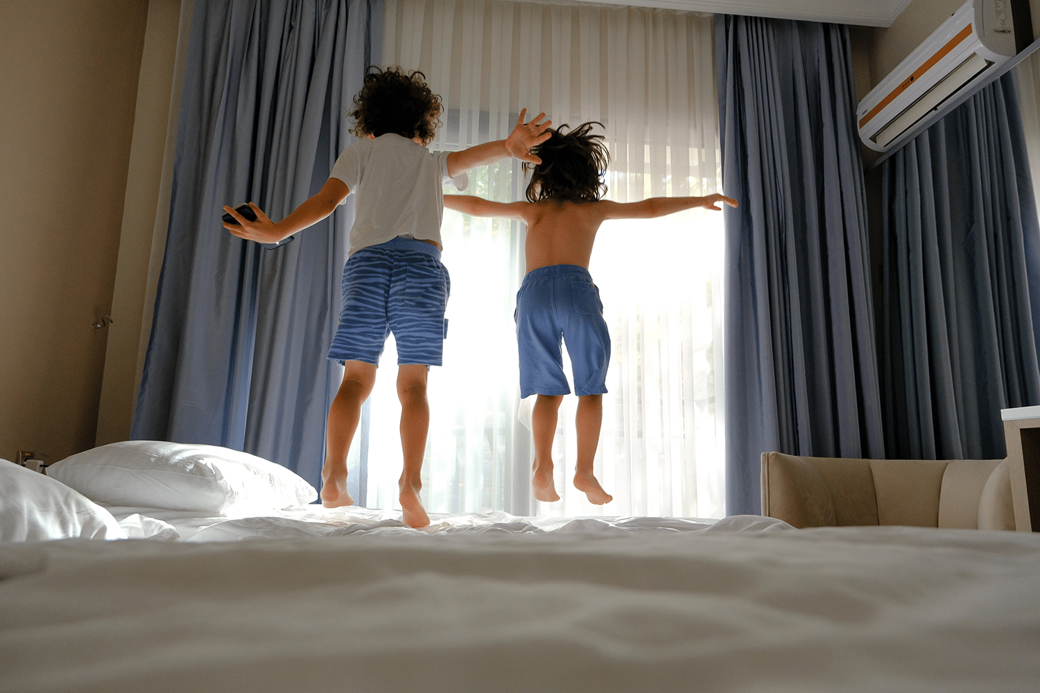17 Years of Family Travel Taught Us Every Trick for Fitting 4 People in a Hotel Room 12 Kids Jumping on a hotel bed